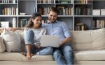 couple is using laptop together