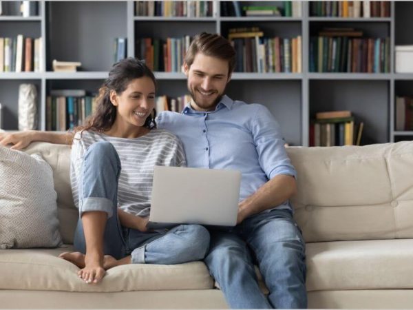 couple is using laptop together